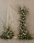 Le Rosse Studio premium real-touch floral rental installation with ivory draping, white botanical meadows, and ceremony backdrop