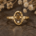Le Rosse Studio gold memorial botanical relic ring with preserved botanical keepsake inside a clear oval setting