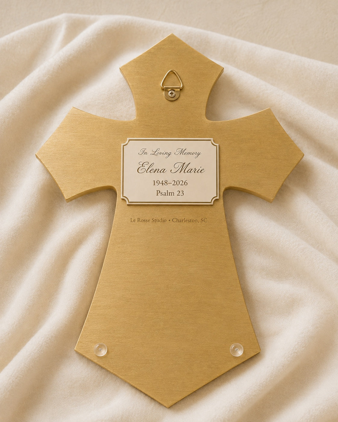 Back of personalized Le Rosse resin cross with hanging hardware and plaque