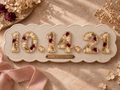 Le Rosse Studio Wedding Date botanical keepsake with scalloped floral resin numbers on a linen display plaque.